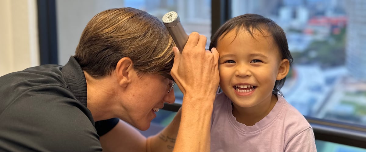 Doctor examines a child's ear