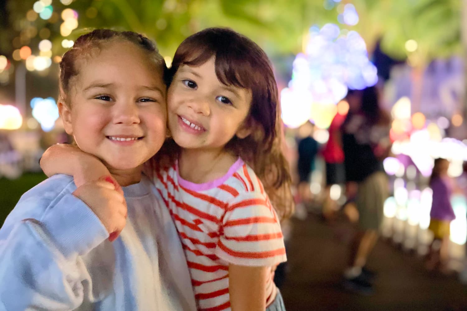 Keānuenue Pediatrics Smiling young girls hug each other