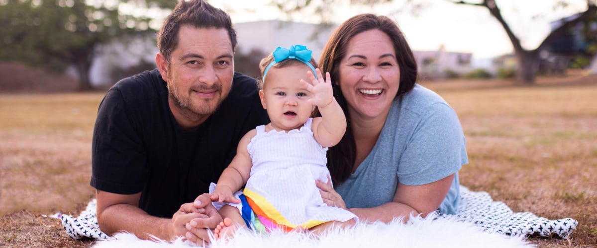 Smiling parents with their toddler
